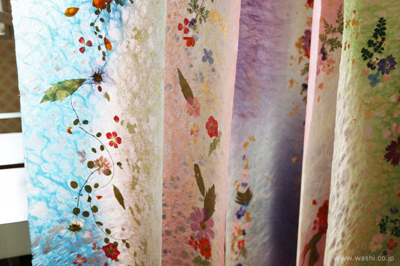 工房で吊るして乾燥させている、美しい押し花入りの手染め和紙